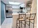 Efficient white kitchen with stainless steel appliances and a convenient breakfast bar at 103 Cypress Pond Rd # 103, Palm Harbor, FL 34683