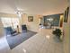 Spacious living room with tiled floors, ceiling fan, and sliding glass doors leading to outdoor space at 103 Cypress Pond Rd # 103, Palm Harbor, FL 34683