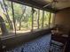 Relaxing screened-in porch with tranquil views of the outdoors at 103 Cypress Pond Rd # 103, Palm Harbor, FL 34683