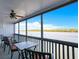 Relaxing screened balcony showcasing serene waterfront views and comfortable seating for enjoying the outdoors at 821 Bahia Del Sol Dr # 43, Ruskin, FL 33570