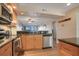 Open kitchen featuring granite countertops, stainless steel appliances, and breakfast bar at 821 Bahia Del Sol Dr # 43, Ruskin, FL 33570