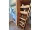 Kitchen cabinet with pull-out shelves and adjacent washer/dryer setup at 821 Bahia Del Sol Dr # 43, Ruskin, FL 33570