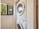 Efficient laundry area with a stacked washer and dryer unit, maximizing space and convenience at 821 Bahia Del Sol Dr # 43, Ruskin, FL 33570