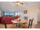 Dining area with glass-top table and four chairs, overlooking a lake at 821 Bahia Del Sol Dr # 43, Ruskin, FL 33570