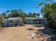Ranch-style home with light blue exterior, a gravel driveway, and mature landscaping at 236 45Th Ave, St Pete Beach, FL 33706
