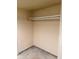 An empty walk-in closet with neutral paint and tile flooring, ready for customized storage solutions at 8304 Bardmoor Blvd # 17 104, Seminole, FL 33777