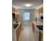 Clean condo kitchen with light wood cabinets and tile floor at 8693 Bardmoor Blvd # 207B, Seminole, FL 33777