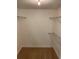 Walk-in closet offers wire shelving and hanging rods at 8693 Bardmoor Blvd # 207B, Seminole, FL 33777