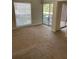 Living room with carpet, sliding glass doors, and window at 8693 Bardmoor Blvd # 207B, Seminole, FL 33777