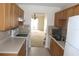 Condo kitchen with light wood cabinets and view to living room at 8693 Bardmoor Blvd # 207B, Seminole, FL 33777