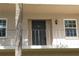Condo building exterior door entrance with a balcony and palm tree at 8693 Bardmoor Blvd # 207B, Seminole, FL 33777