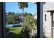 Community pool with lush landscaping and palm trees at 8693 Bardmoor Blvd # 207B, Seminole, FL 33777