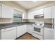 Simple kitchen with white cabinets and granite countertops at 101 Lake Ne Ave # 225, Largo, FL 33771