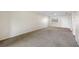 Bright living room with neutral carpeting and an exterior door at 101 Lake Ne Ave # 225, Largo, FL 33771