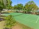 Well-maintained tennis court surrounded by trees at 101 Lake Ne Ave # 225, Largo, FL 33771
