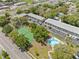 An aerial view of an apartment complex with a pool and tennis court at 101 Lake Ne Ave # 225, Largo, FL 33771