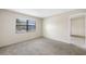 Spacious carpeted bedroom with window and door at 101 Lake Ne Ave # 225, Largo, FL 33771