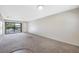 Spacious living room with neutral carpeting and sliding glass doors at 101 Lake Ne Ave # 225, Largo, FL 33771