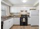 Updated kitchen with white cabinets, granite countertops and black appliances at 101 Lake Ne Ave # 125, Largo, FL 33771