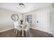 Dining area with glass table and white chairs at 101 Lake Ne Ave # 125, Largo, FL 33771