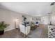 Living room with comfy seating, wood-look floors, and large windows at 101 Lake Ne Ave # 125, Largo, FL 33771