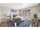 Bedroom with a queen bed, wood-look floors, and blue rug at 101 Lake Ne Ave # 125, Largo, FL 33771