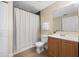 Clean bathroom with shower/tub combo and wood vanity at 101 Lake Ne Ave # 125, Largo, FL 33771