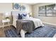 Bright bedroom with a comfy bed, stylish rug, and tasteful wall art at 101 Lake Ne Ave # 125, Largo, FL 33771
