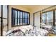 Screened balcony with floral bedding and garden view at 2205 Belleair Rd # A13, Clearwater, FL 33764