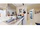 Kitchen features a large sink, wood cabinets, and a view into the bathroom at 2205 Belleair Rd # A13, Clearwater, FL 33764