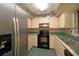 Kitchen features stainless steel appliances and green tile countertops at 1901 Ohio Ne Ave, St Petersburg, FL 33703