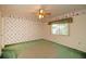Bedroom with green carpet, window, ceiling fan and themed wallpaper at 1901 Ohio Ne Ave, St Petersburg, FL 33703