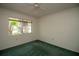 Bedroom with green carpet, window, and ceiling fan at 1901 Ohio Ne Ave, St Petersburg, FL 33703