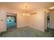 Dining room features a crystal chandelier and green carpet at 1901 Ohio Ne Ave, St Petersburg, FL 33703