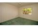 Bright bedroom with green carpet, window, and ceiling fan at 1901 Ohio Ne Ave, St Petersburg, FL 33703
