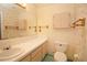 Bathroom with single sink vanity, toilet and wall cabinets at 1901 Ohio Ne Ave, St Petersburg, FL 33703