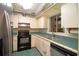 Kitchen features stainless steel appliances and green tile countertops at 1901 Ohio Ne Ave, St Petersburg, FL 33703