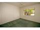 Bright bedroom with green carpet, window, and ceiling fan at 1901 Ohio Ne Ave, St Petersburg, FL 33703