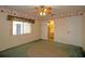 Bedroom with green carpet, ceiling fan, and access to bathroom at 1901 Ohio Ne Ave, St Petersburg, FL 33703