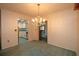 Bright dining room with chandelier and kitchen view at 1901 Ohio Ne Ave, St Petersburg, FL 33703