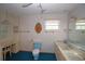 Bathroom features a vanity, toilet and window at 1901 Ohio Ne Ave, St Petersburg, FL 33703