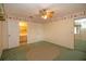Bedroom with green carpet, ceiling fan and access to bathroom at 1901 Ohio Ne Ave, St Petersburg, FL 33703
