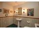 Small bathroom with pedestal sink and wood paneling at 1901 Ohio Ne Ave, St Petersburg, FL 33703
