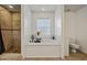 Bathroom with soaking tub, shower, and tile flooring at 1729 Oakwood Estates Dr, Plant City, FL 33563