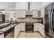 Modern kitchen with stainless steel appliances and granite countertops at 1729 Oakwood Estates Dr, Plant City, FL 33563