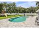 Inviting kidney-shaped pool with a patio and fenced backyard at 1729 Oakwood Estates Dr, Plant City, FL 33563