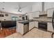 Open kitchen with granite countertops, stainless steel appliances, and island at 1729 Oakwood Estates Dr, Plant City, FL 33563