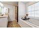 Main bathroom with a shower, soaking tub, and double vanity at 1729 Oakwood Estates Dr, Plant City, FL 33563