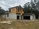 View of new home's concrete block and lumber construction, revealing attached garage, and a spacious design at 8418 Fussell Dr, Wesley Chapel, FL 33545