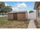 Large backyard with a storage shed and a walkway at 4036 Sunray Dr, Holiday, FL 34691